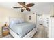 Bedroom features a comfy bed, ceiling fan, and ensuite bathroom at 9525 Blind Pass Rd # 301, St Pete Beach, FL 33706