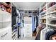Walk-in closet with custom shelving, drawers, and ample storage space at 9525 Blind Pass Rd # 301, St Pete Beach, FL 33706
