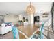 Bright dining area with a unique light fixture and a view of the open kitchen at 9525 Blind Pass Rd # 301, St Pete Beach, FL 33706