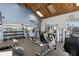 Community gym with modern equipment, mirrors, high ceilings, and natural light at 9525 Blind Pass Rd # 301, St Pete Beach, FL 33706