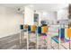 Stylish kitchen bar area with unique colorful bar stools and a clean design at 9525 Blind Pass Rd # 301, St Pete Beach, FL 33706