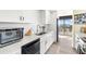 Modern kitchen with stainless steel appliances, natural light, and a view at 9525 Blind Pass Rd # 301, St Pete Beach, FL 33706
