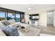Inviting living room featuring a comfy white couch and picturesque water views from the balcony at 9525 Blind Pass Rd # 301, St Pete Beach, FL 33706