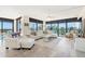 Bright living room featuring a comfortable white sofa, expansive windows, and beautiful views at 9525 Blind Pass Rd # 301, St Pete Beach, FL 33706