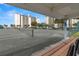 Well-maintained tennis court with clear view of condos and parking at 9525 Blind Pass Rd # 301, St Pete Beach, FL 33706