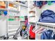 Organized walk-in closet with multiple shelves, hanging rods, and ample storage space at 9525 Blind Pass Rd # 301, St Pete Beach, FL 33706