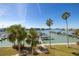 Scenic view overlooking a boat marina from an elevated position with palm trees at 9525 Blind Pass Rd # 301, St Pete Beach, FL 33706