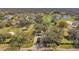 Expansive aerial view of community golf course surrounded by lush trees and beautiful homes at 1008 Royal Birkdale Dr, Tarpon Springs, FL 34688