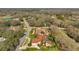 Overhead shot of homes near a golf course, lush trees, and verdant landscaping at 1008 Royal Birkdale Dr, Tarpon Springs, FL 34688