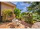Charming brick back patio with garden view and shaded seating area, perfect for outdoor enjoyment at 1008 Royal Birkdale Dr, Tarpon Springs, FL 34688