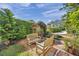 Lush backyard showcasing a tranquil seating area nestled among well-maintained green landscaping at 1008 Royal Birkdale Dr, Tarpon Springs, FL 34688