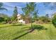 Lush green backyard highlighting the home's exterior and well-maintained landscaping at 1008 Royal Birkdale Dr, Tarpon Springs, FL 34688