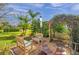 Serene backyard with seating area, lush green landscaping, and peaceful ambiance for outdoor relaxation at 1008 Royal Birkdale Dr, Tarpon Springs, FL 34688
