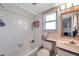 Compact bathroom featuring tub-shower combo and a vanity, designed for functionality in a cozy setting at 1008 Royal Birkdale Dr, Tarpon Springs, FL 34688