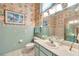 Well-lit bathroom featuring a tub, vanity, and floral wallpaper at 1008 Royal Birkdale Dr, Tarpon Springs, FL 34688