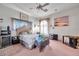 Well-lit bedroom with bed, fan, and curated decor, offering a blend of relaxation and personal style at 1008 Royal Birkdale Dr, Tarpon Springs, FL 34688