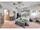 Bright bedroom with a collection of stuffed animals atop a bed and a ceiling fan for ventilation and comfort at 1008 Royal Birkdale Dr, Tarpon Springs, FL 34688