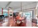 Open-concept living area with a formal dining table, fireplace, and seamless access to the outdoor pool at 1008 Royal Birkdale Dr, Tarpon Springs, FL 34688
