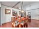 Spacious dining room featuring an oval wood table set, pendant lighting, and decorative wall art at 1008 Royal Birkdale Dr, Tarpon Springs, FL 34688
