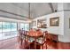 Elegant dining room with a wooden table, chandelier, and large windows offering a view of the backyard pool at 1008 Royal Birkdale Dr, Tarpon Springs, FL 34688