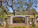 A welcoming community entrance sign with stone pillars and decorative iron accents at 1008 Royal Birkdale Dr, Tarpon Springs, FL 34688