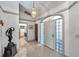 Welcoming entryway with tiled floors, modern lighting, and glass block windows for natural light at 1008 Royal Birkdale Dr, Tarpon Springs, FL 34688