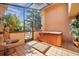 Enclosed patio featuring a hot tub, tiled floors, and elegant decor providing a private and luxurious space at 1008 Royal Birkdale Dr, Tarpon Springs, FL 34688
