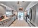 Modern kitchen featuring white tile floor, stainless appliances, and plenty of cabinet space for storage and organization at 1008 Royal Birkdale Dr, Tarpon Springs, FL 34688
