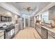 Functional kitchen featuring neutral-toned cabinetry, stainless steel appliances, and ample countertop space at 1008 Royal Birkdale Dr, Tarpon Springs, FL 34688