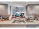 Kitchen view to an open-concept living space, with a view of the fireplace and the living room at 1008 Royal Birkdale Dr, Tarpon Springs, FL 34688