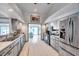 Well-lit kitchen with stainless steel appliances and white cabinets providing a clean and functional space at 1008 Royal Birkdale Dr, Tarpon Springs, FL 34688
