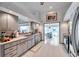 Bright kitchen with a view to the dinning area, updated appliances, and white cabinets for ample storage at 1008 Royal Birkdale Dr, Tarpon Springs, FL 34688