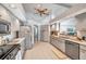 Functional kitchen with neutral cabinets, stainless steel appliances, and tile flooring for easy maintenance at 1008 Royal Birkdale Dr, Tarpon Springs, FL 34688