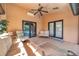Comfortable and airy covered patio with ceiling fan, providing a relaxing space overlooking the pool and backyard at 1008 Royal Birkdale Dr, Tarpon Springs, FL 34688