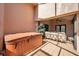 Private patio featuring a hot tub, outdoor seating, and direct access to indoor living space at 1008 Royal Birkdale Dr, Tarpon Springs, FL 34688
