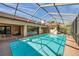 Large screened pool with clear water, complemented by covered patio areas and ample sunlight at 1008 Royal Birkdale Dr, Tarpon Springs, FL 34688