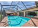 Enjoy this sparkling pool with screened enclosure, offering both privacy and clear views of the property at 1008 Royal Birkdale Dr, Tarpon Springs, FL 34688