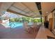 Screened pool with outdoor dining and seating for relaxation and entertaining near lush landscaping at 1008 Royal Birkdale Dr, Tarpon Springs, FL 34688