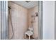 Accessible walk-in shower featuring a seat and handheld shower head at 1008 Royal Birkdale Dr, Tarpon Springs, FL 34688