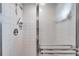 Bright tiled shower with built-in shelving and glass doors at 1008 Royal Birkdale Dr, Tarpon Springs, FL 34688