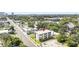 Aerial view of modern townhomes highlighted with red arrow, surrounded by lush greenery and a city skyline at 101 W Warren Ave # 1, Tampa, FL 33602