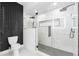 Sleek bathroom featuring a glass shower with double shower heads and unique tile design at 101 W Warren Ave # 1, Tampa, FL 33602