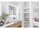 Modern bathroom with vanity, stylish mirror, and open shelving at 101 W Warren Ave # 1, Tampa, FL 33602