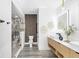 Modern bathroom with glass enclosed shower, dual vanity with wood cabinets, and decorative wall accents at 101 W Warren Ave # 1, Tampa, FL 33602