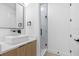 Modern bathroom with a stylish vessel sink, black fixtures, and a glass-enclosed shower with sleek, white tiling at 101 W Warren Ave # 1, Tampa, FL 33602
