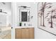 Modern powder room featuring wood vanity, black fixtures, and palm tree wall art at 101 W Warren Ave # 1, Tampa, FL 33602