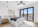 Bright bedroom featuring a ceiling fan, a comfy bed, and sliding glass doors to a patio with city views at 101 W Warren Ave # 1, Tampa, FL 33602