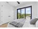Bright bedroom with a large window, modern ceiling fan, and neutral decor at 101 W Warren Ave # 1, Tampa, FL 33602