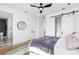 Bedroom boasts a ceiling fan, modern lighting, and a sliding barn door leading to closet at 101 W Warren Ave # 1, Tampa, FL 33602