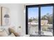 Bedroom view showcases city skyline from sliding glass doors, artwork, and stylish modern lighting fixtures at 101 W Warren Ave # 1, Tampa, FL 33602